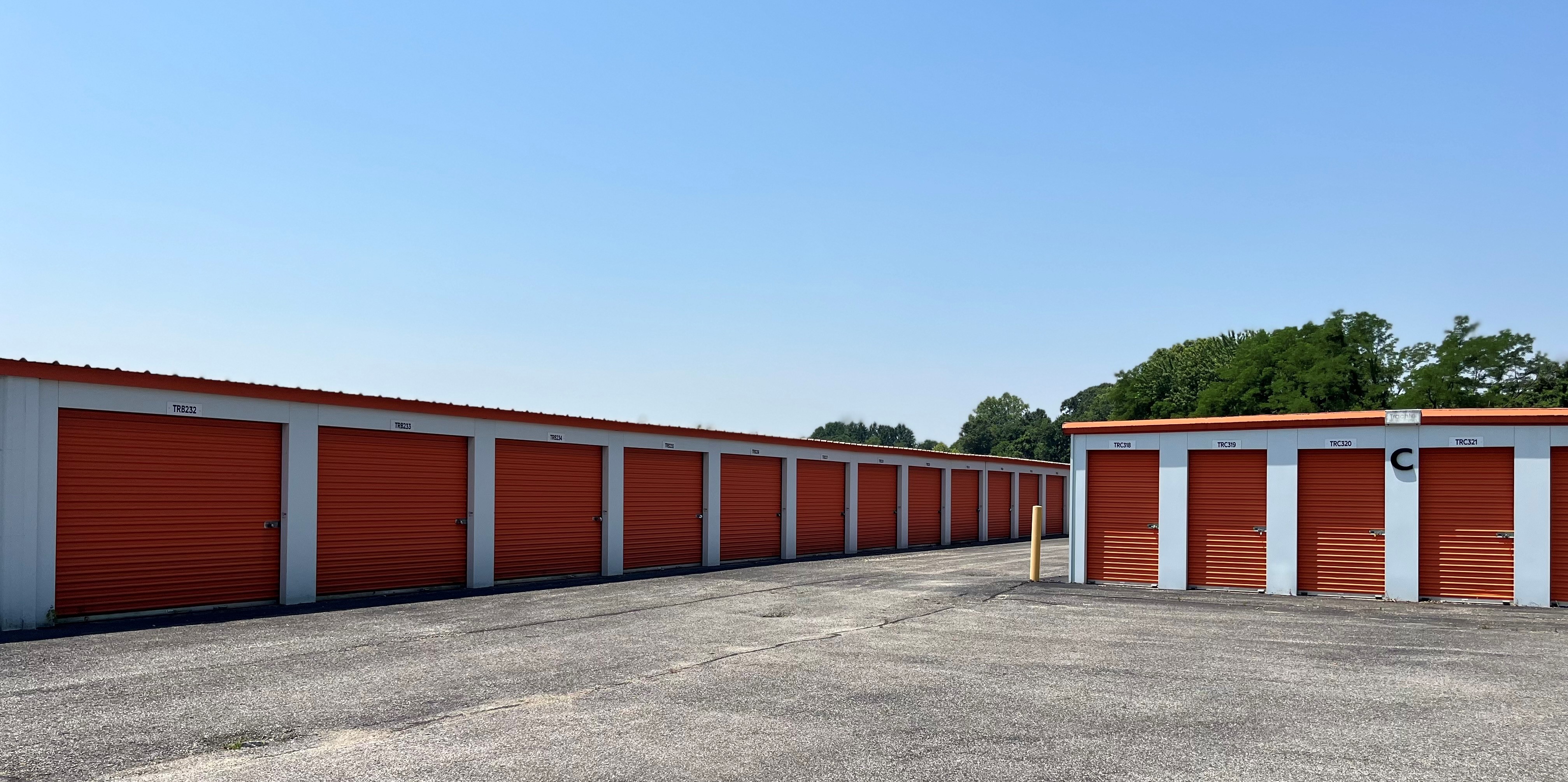 Jasper's Truman Rd Access Storage, offering drive-up units with white doors and expansive, well-paved driveways for smooth access.